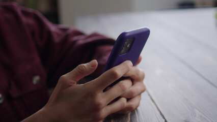 A young lady is watching something on the phone