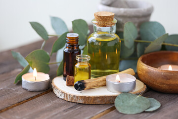 Assortment of natural oils in glass bottles on wooden background. Concept of pure organic ingredients in cosmetology. Bath accessories, atmosphere of harmony, relax. Close up macro. Healthy lifestyle