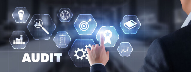 Businessman is selecting Audit on the virtual screen on city background