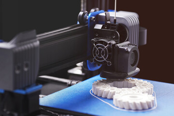 gantry with print head and x-carrier of black FDM-3D-printer with blue and grey parts....
