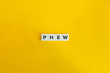 Phew Word on Letter Tiles on Yellow Background. Minimal aesthetics.