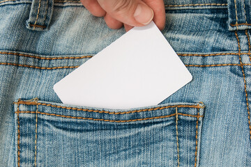 Hand taking white label, card with information copy space in a jeans pocket, sale and discount concept