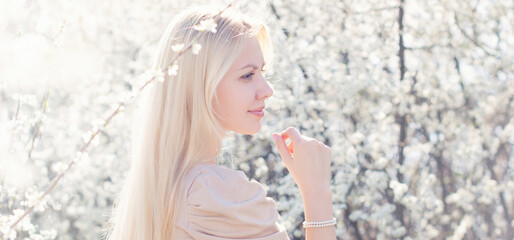 Natural beauty and parfume cosmetics. Young beautiful blonde woman in spring blossom garden - 486974132