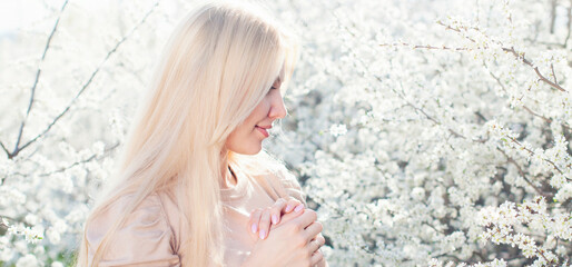 Natural beauty and parfume cosmetics. Young beautiful blonde woman in spring blossom garden - 486974194