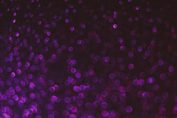 Bokeh light background. Blur neon circles. Fluorescent sparkles. Defocused purple pink color...