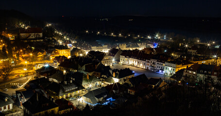 Kazimierz Dolny at night. Illuminated market square in Kazimierz Dolny. Top view of three crosses