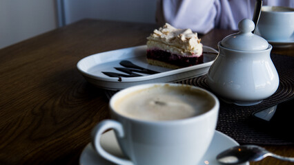 Piece of cake with coffe in cafe. 