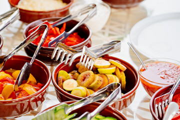 bowls with chopped vegetables and fruits on the table. 