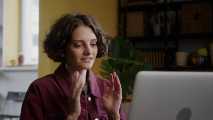 A beautiful girl is talking with her friend on the Internet 