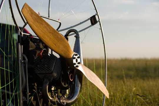 A closeup of a paramotor with a wooden propeller for individual paralet flights. Extreme sports. Selective focus