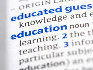 Education - English dictionary definition of the word - photo of a dictionary page with paper grain texture - selective focus on the word