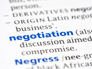 Negotiation - English dictionary definition of the word - photo of a dictionary page with paper grain texture - selective focus on the word