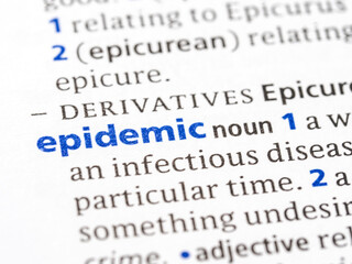 Epidemic - English dictionary definition of the word - photo of a dictionary page with paper grain texture - selective focus on the word