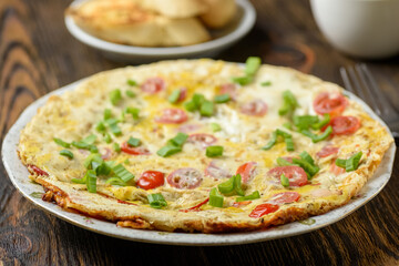 delicious breakfast omelette with vegetables, croutons and coffee