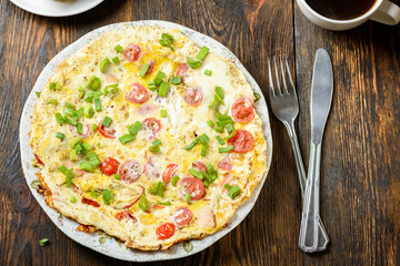 delicious breakfast omelette with vegetables, croutons and coffee