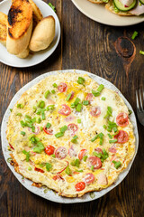 delicious breakfast omelette with vegetables, croutons and coffee - 486978546