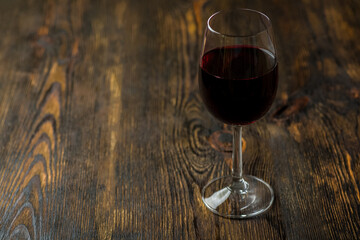A glass of wine on a wooden table