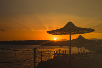 Red colorful sunset landscape  on the seashore in Egypt.  Orange yellow beautiful sunset landscape. Seashore exotic vacation.