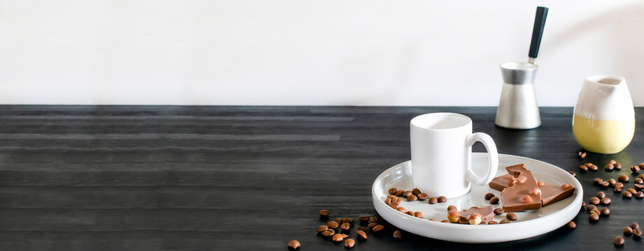 White Espresso Cup, Mug, Chocolate, Coffee Beans On Plate Kitchen Table, Utensils Dishware, Coffee Pot On Black Wooden Shelf. Early Morning Home Hot Beverage Breakfast, Mockup Logo Design Copy Space