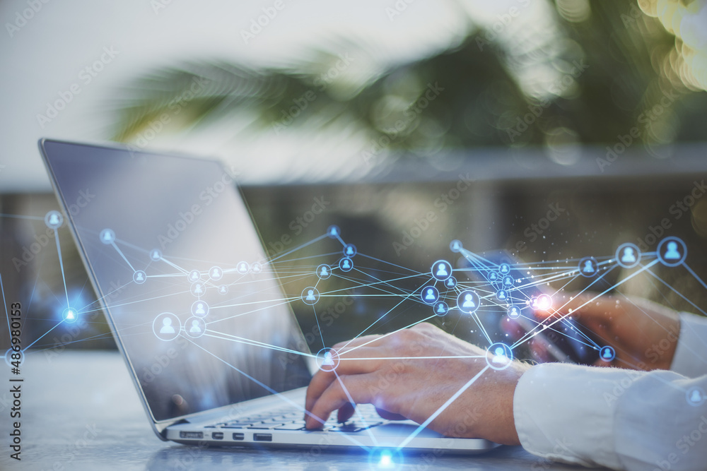 Poster Close up of businessman hands at desktop using laptop and smartphone with abstract glowing polygonal network with people icons. Blurry background. 