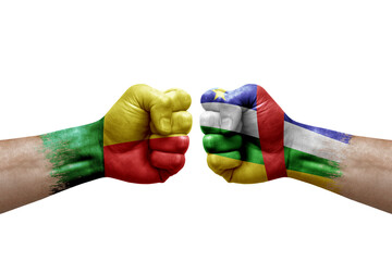 Two hands punch to each others on white background. Country flags painted fists, conflict crisis concept between benin and central african republic