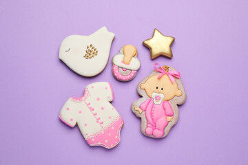 Set of baby shower cookies on lilac background, flat lay