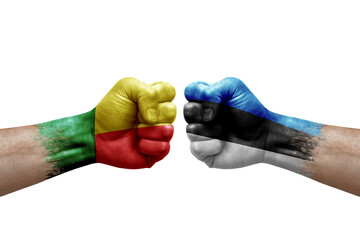 Two hands punch to each others on white background. Country flags painted fists, conflict crisis concept between benin and estonia