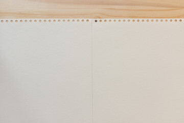 blank coil notebook paper background on wood