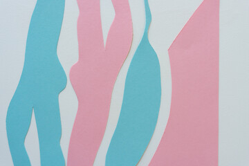 pink and blue paper shapes on a light background