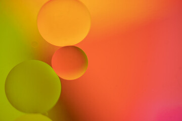 Several drops on light orange colors and green coior background