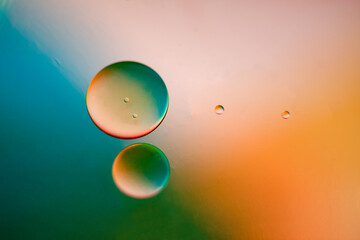 Several drops in light orange colors and teal coior background