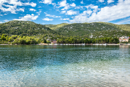 bay in Ploce in Croatia, summer day in a holiday resort in Croatia, clear water, boats in ploce harbor, green hills in the mediterranean part of Croatia, Dalmatia