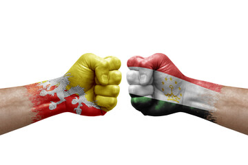 Two hands punch to each others on white background. Country flags painted fists, conflict crisis concept between bhutan and tajikistan