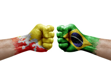 Two hands punch to each others on white background. Country flags painted fists, conflict crisis concept between bhutan and brazil