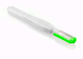 green pen corrector isolated on a white background
