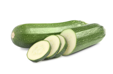 Whole and cut ripe zucchinis on white background