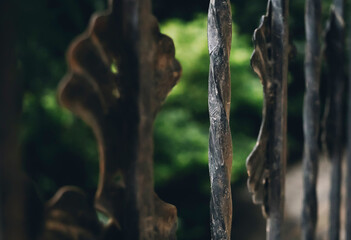 Forged metal fence bars close up, vintage art details