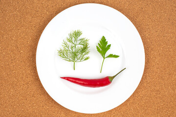 Fresh red hot peppers on a white plate. Vitamin wholesome food.