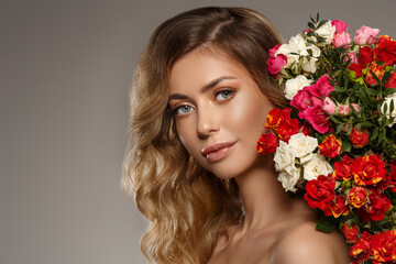 Fashion model with flowers. Spring girl. Woman with a summer bouquet of flowers.