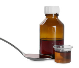 Bottle of cough syrup, spoon and measuring cup on white background
