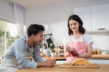 Asian young new marriage couple spend time together in kitchen at home. 