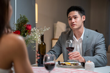 Asian young couple having dinner to celebrate valentine's day together. 