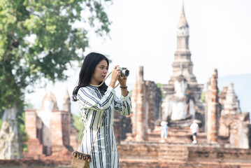 Asian tourists is visiting at Sukhothai in Thailand.