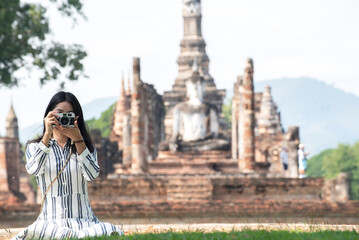 Asian tourists is visiting at Sukhothai in Thailand.