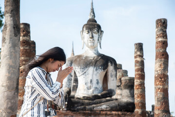 Asian tourists is visiting at Sukhothai in Thailand.