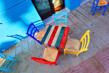 colors table chairs old style in outdoor coffee shop in greece in summer
