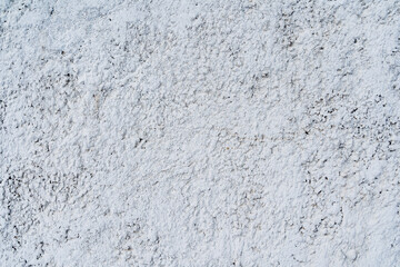 White textured surface. An outdoor wall with a rough surface. Old plaster. Textured surface