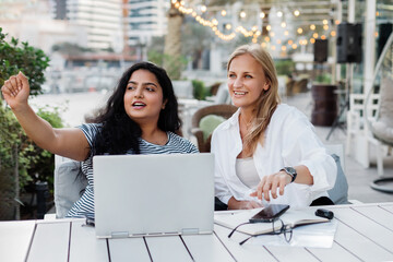 Two colleagues discuss a common project while working together outside the office.