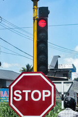 A piture of a traffic signal showing red sign for stopping the vehicle