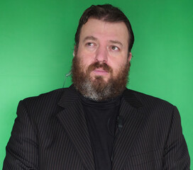 Portrait of bearded security man in front of green screen